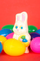 White easter bunny and plastic eggs