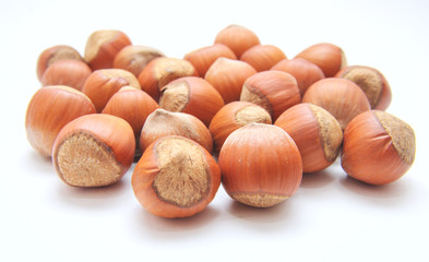 Hazelnuts over the white background