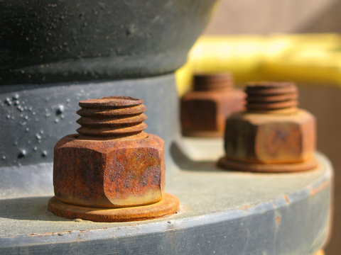 Old rusty metal nut on iron water valve