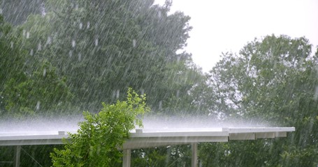 Raining over a white roof in a hurricane storm