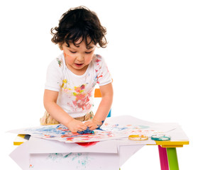Little boy painting.