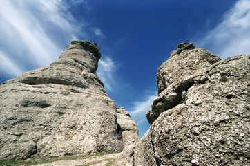 Stone formations on blue sky background.
