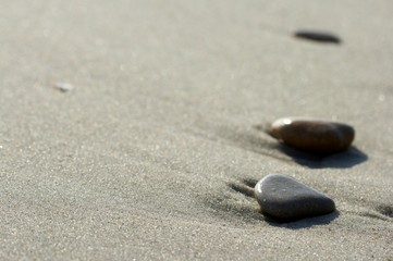Fototapeta na wymiar Stones on sand at the sea, a pebble