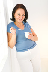 Woman eating yoghurt © Tomasz Trojanowski