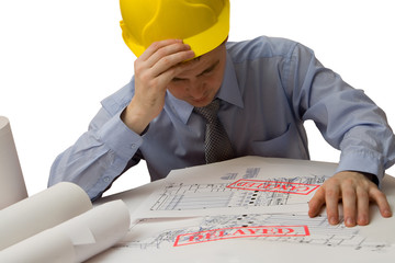sad architect with blueprints