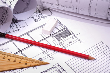 engineering drawing on drawing desk with rulers and pencils