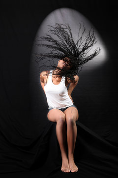 wind - lovely young afro-american woman with long flapping hairs