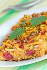 Italian baked pastries on a white plate sprinkled green pepper