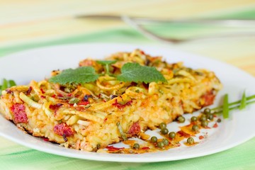 Italian baked pastries on a white plate sprinkled green pepper