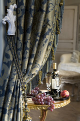 Luxurious curtain from woollen cloth with tassel. Blue and gold