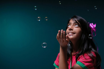 Girl observing soap bubbles