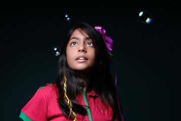 Girl watching soap bubbles