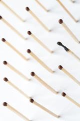 White background with rows of standing matches