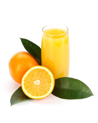 Fruits with green leaves and glass of juice