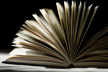 open book enlighted with black background