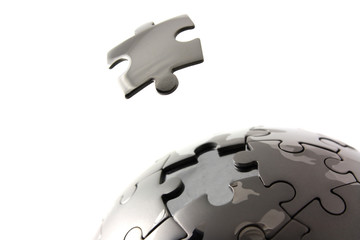 Puzzle globe with floating piece