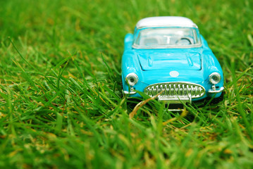 Blue retro toy car on grass