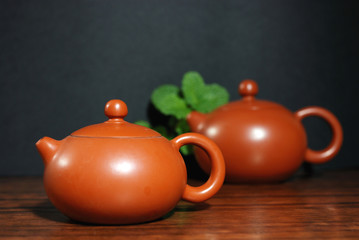 Asian teapot with sprigs of mint for tea