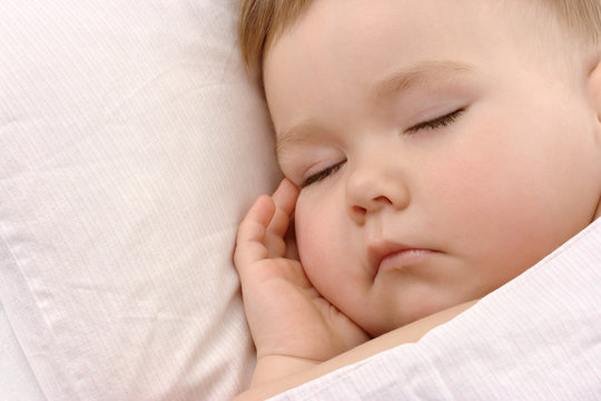 Child sleeping with hand under his cheek