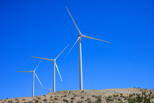 desert wind turbines with blue sky background