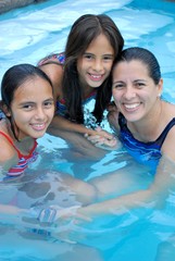 Mother and beautiful daughter in a pool