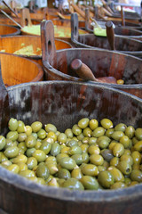 olives in a wooden barrel at the marketplace