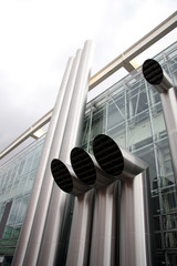 Metallic tubes on the wall of a moder building