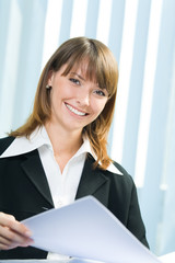 Young businesswoman working with documents at office
