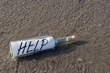 Bottle in water on the beach