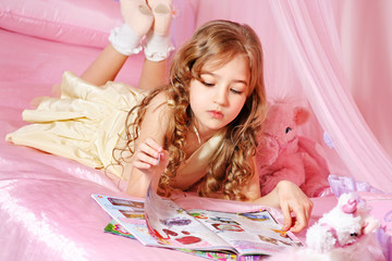 Beautiful little girl reading magazine © Mila Supinskaya 