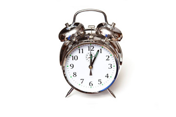 Traditional alarm clock isolated on a white background.