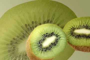 Kiwi on background of kiwi slice.