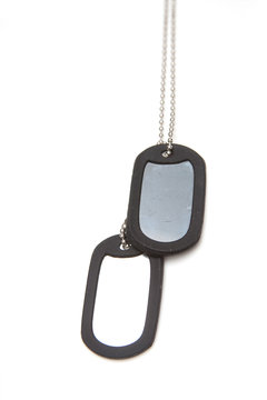 Millatry style dog tags on a white studio background