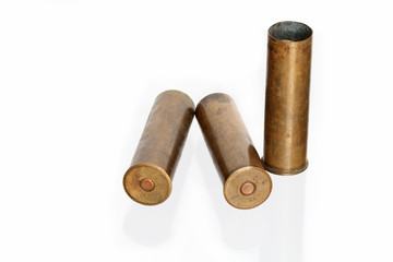 Three old brass cartridges for fowling piece isolated on white