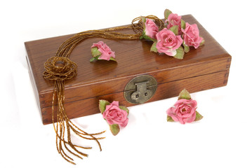 Wooden box with roses and necklace
