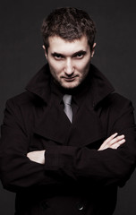 portrait of stern man in black coat
