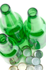 Green beer bottles and covers on a white background