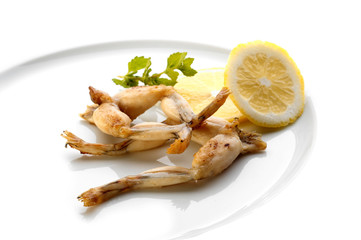 Fried frog legs on white plate