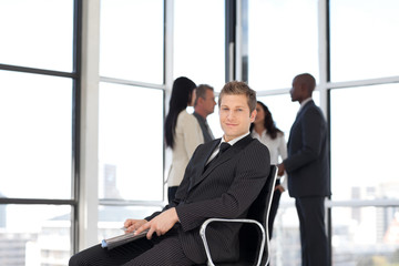 Businesss man in office sitting on chair