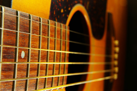 closeup of a guitar neck and strings