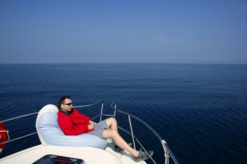 Man on bow boat relaxed on bean bag