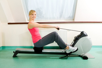 Woman exercise on rowing machine