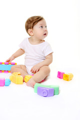 Fototapeta na wymiar Baby playing with colored blocks