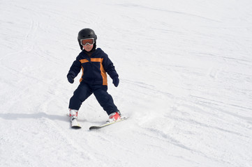 Fototapeta na wymiar Four year old child skiing alone