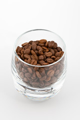 coffea beans in glass on white background