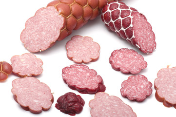 Cutting sausage on white macro