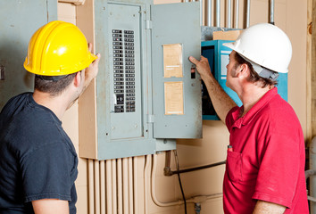 Repairmen Examine Electrical Panel