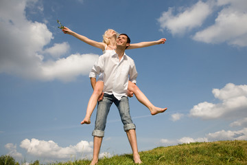 Happy Young love Couple - jumping under blue sky