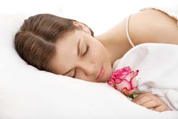 Obraz na płótnie Canvas The sleeping girl with a flower