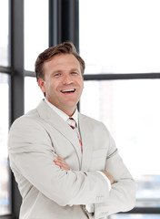 Senior Business Man with arms folded in Front of team